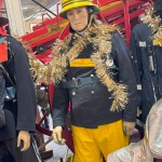 1970s Firemans Uniform With Yellow Cork Helmet Nomex Fire Tunic And The Iconic Yellow Waterproof Overtrousers mannequin-man performming as a Museum Dummy: The Essex Fire Museum added some christmas decorations to the historic firefighter uniform dispolay for Essex Fire Museum on 17/12/2023