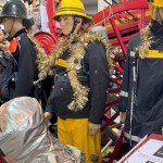 1970s Firemans Uniform With Yellow Cork Helmet Nomex Fire Tunic And The Iconic Yellow Waterproof Overtrousers mannequin-man performming as a Museum Dummy: The Essex Fire Museum added some christmas decorations to the historic firefighter uniform dispolay for Essex Fire Museum on 17/12/2023