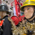 1970s Firemans Uniform With Yellow Cork Helmet Nomex Fire Tunic And The Iconic Yellow Waterproof Overtrousers mannequin-man performming as a Museum Dummy: The Essex Fire Museum added some christmas decorations to the historic firefighter uniform dispolay for Essex Fire Museum on 17/12/2023