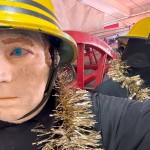 1970s Firemans Uniform With Yellow Cork Helmet Nomex Fire Tunic And The Iconic Yellow Waterproof Overtrousers mannequin-man performming as a Museum Dummy: The Essex Fire Museum added some christmas decorations to the historic firefighter uniform dispolay for Essex Fire Museum on 17/12/2023