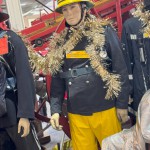 1970s Firemans Uniform With Yellow Cork Helmet Nomex Fire Tunic And The Iconic Yellow Waterproof Overtrousers mannequin-man performming as a Museum Dummy: The Essex Fire Museum added some christmas decorations to the historic firefighter uniform dispolay for Essex Fire Museum on 17/12/2023