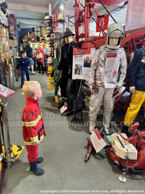 Mannequin demonstrating hazard protection clothing. This mannequin is wearing a Heat Resistant Aluminized Foil Refinery Proximity Suit. - Essex Fire Museum Living Mannequin Wearing A Heat Resistant Aluminized Foil Refinery Proximity Suit Mannequin demonstrating hazard protection clothing. This mannequin is wearing a Heat Resistant Aluminized Foil Refinery Proximity Suit. - Essex Fire Museum Living Mannequin Wearing A Heat Resistant Aluminized Foil Refinery Proximity Suit