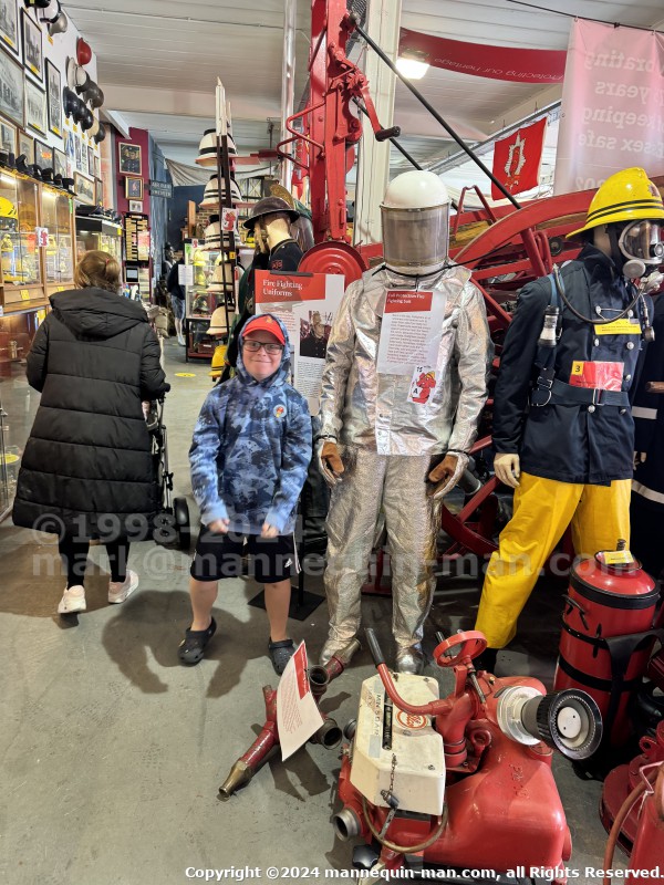 Mannequin demonstrating hazard protection clothing. This mannequin is wearing a Heat Resistant Aluminized Foil Refinery Proximity Suit. - Essex Fire Museum Living Mannequin Wearing A Heat Resistant Aluminized Foil Refinery Proximity Suit Mannequin demonstrating hazard protection clothing. This mannequin is wearing a Heat Resistant Aluminized Foil Refinery Proximity Suit. - Essex Fire Museum Living Mannequin Wearing A Heat Resistant Aluminized Foil Refinery Proximity Suit