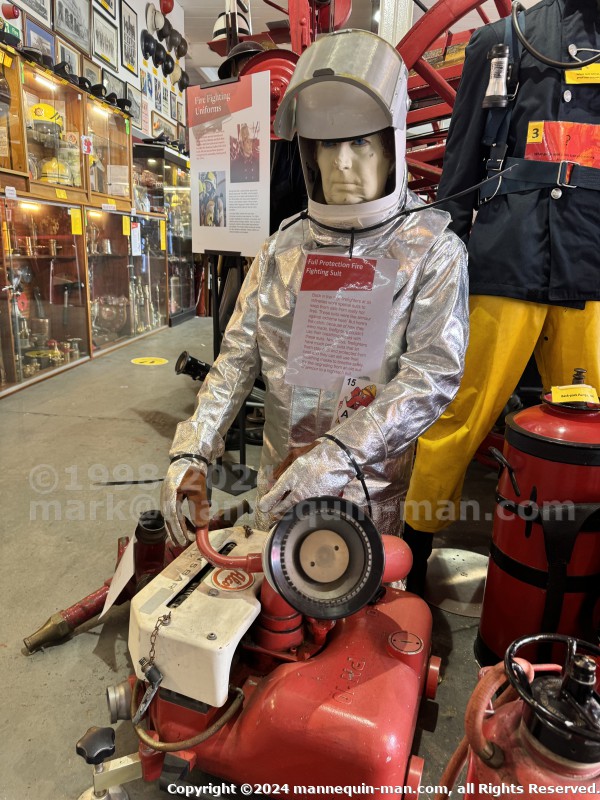 Mannequin demonstrating hazard protection clothing. This mannequin is wearing a Heat Resistant Aluminized Foil Refinery Proximity Suit. - Essex Fire Museum Living Mannequin Wearing A Heat Resistant Aluminized Foil Refinery Proximity Suit Mannequin demonstrating hazard protection clothing. This mannequin is wearing a Heat Resistant Aluminized Foil Refinery Proximity Suit. - Essex Fire Museum Living Mannequin Wearing A Heat Resistant Aluminized Foil Refinery Proximity Suit