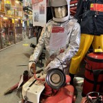 Mannequin demonstrating hazard protection clothing. This mannequin wearing a British Aircraft Crash Rescue Helmet with an Aluminised Foil Heat Resistant Refinery Proximity Suit. The mannequin is cable tied at the wrist to stop it falling over