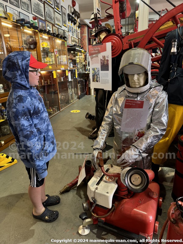 Mannequin demonstrating hazard protection clothing. This mannequin is wearing a Heat Resistant Aluminized Foil Refinery Proximity Suit. - Essex Fire Museum Living Mannequin Wearing A Heat Resistant Aluminized Foil Refinery Proximity Suit Mannequin demonstrating hazard protection clothing. This mannequin is wearing a Heat Resistant Aluminized Foil Refinery Proximity Suit. - Essex Fire Museum Living Mannequin Wearing A Heat Resistant Aluminized Foil Refinery Proximity Suit