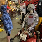 Essex Fire Museum Living Mannequin Wearing A Heat Resistant Aluminized Foil Refinery Proximity Suit mannequin-man performming as a Museum Dummy: Mannequin demonstrating hazard protection clothing. This mannequin is wearing a Heat Resistant Aluminized Foil Refinery Proximity Suit. for Essex Fire Museum on 28/05/2024