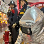 Iconic 1970s Firemans Uniform With Yellow Yellow Waterproof Overtrousers And Yellow Cork Helmet With Blue Nomex Fire Tunic mannequin-man performming as a Museum Dummy: Mannequin wearing a 1976 Nomex jacket, yellow cork helmet and classic yellow PVC leggings. for Essex Fire Museum on 26/11/2023