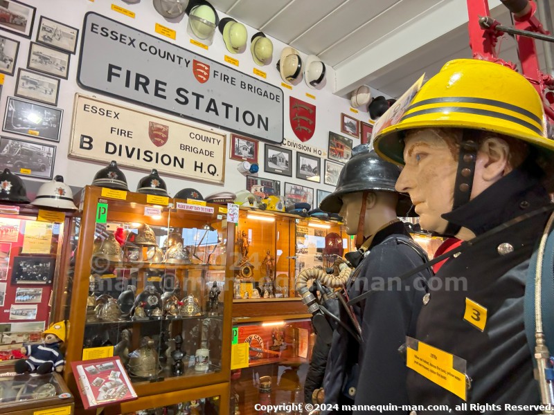 Mannequin wearing a 1976 Nomex jacket, yellow cork helmet and classic yellow PVC leggings. - Iconic 1970s Firemans Uniform With Yellow Yellow Waterproof Overtrousers And Yellow Cork Helmet With Blue Nomex Fire Tunic Mannequin wearing a 1976 Nomex jacket, yellow cork helmet and classic yellow PVC leggings. - Iconic 1970s Firemans Uniform With Yellow Yellow Waterproof Overtrousers And Yellow Cork Helmet With Blue Nomex Fire Tunic