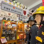 Iconic 1970s Firemans Uniform With Yellow Yellow Waterproof Overtrousers And Yellow Cork Helmet With Blue Nomex Fire Tunic mannequin-man performming as a Museum Dummy: Mannequin wearing a 1976 Nomex jacket, yellow cork helmet and classic yellow PVC leggings. for Essex Fire Museum on 26/11/2023