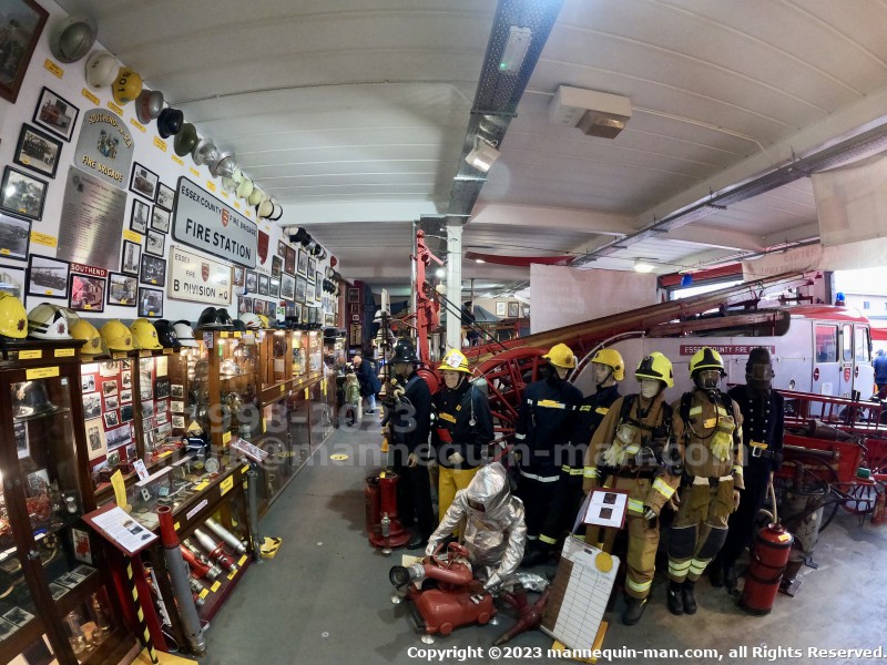 Display of Mannequins wearing firefigher uniforms from the 1950s to the present day. - Iconic 1970s Firemans Uniform With Yellow Yellow Waterproof Overtrousers And Yellow Cork Helmet With Blue Nomex Fire Tunic Display of Mannequins wearing firefigher uniforms from the 1950s to the present day. - Iconic 1970s Firemans Uniform With Yellow Yellow Waterproof Overtrousers And Yellow Cork Helmet With Blue Nomex Fire Tunic