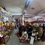 Iconic 1970s Firemans Uniform With Yellow Yellow Waterproof Overtrousers And Yellow Cork Helmet With Blue Nomex Fire Tunic mannequin-man performming as a Museum Dummy: Display of Mannequins wearing firefigher uniforms from the 1950s to the present day. for Essex Fire Museum on 26/11/2023