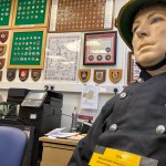 Iconic 1970s Firemans Uniform With Yellow Yellow Waterproof Overtrousers And Yellow Cork Helmet With Blue Nomex Fire Tunic mannequin-man performming as a Museum Dummy: Mannequin wearing a 1976 Nomex jacket, yellow cork helmet and classic yellow PVC leggings. for Essex Fire Museum on 26/11/2023