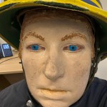 Iconic 1970s Firemans Uniform With Yellow Yellow Waterproof Overtrousers And Yellow Cork Helmet With Blue Nomex Fire Tunic mannequin-man performming as a Museum Dummy: Mannequin wearing a 1976 Nomex jacket, yellow cork helmet and classic yellow PVC leggings. for Essex Fire Museum on 26/11/2023