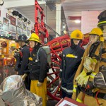 Iconic 1970s Firemans Uniform With Yellow Yellow Waterproof Overtrousers And Yellow Cork Helmet With Blue Nomex Fire Tunic mannequin-man performming as a Museum Dummy: Mannequin wearing a 1976 Nomex jacket, yellow cork helmet and classic yellow PVC leggings. for Essex Fire Museum on 26/11/2023