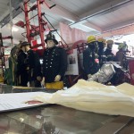 Living Mannequin Wearing 1950s Firefighter Uniform Black Helmet Yellow Leggings Essex Fire Museum mannequin-man performming as a Museum Dummy: Mannequin man wearing 1950-1960 firefighter uniform and breathing apparatus amusing the visitors for Essex Fire Museum on 26/05/2024