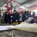 Living Mannequin Wearing 1950s Firefighter Uniform Black Helmet Yellow Leggings Essex Fire Museum mannequin-man performming as a Museum Dummy: Mannequin man wearing 1950-1960 firefighter uniform and breathing apparatus amusing the visitors for Essex Fire Museum on 26/05/2024