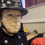Mannequin man wearing 1950-1960 firefighter uniform and breathing apparatus amusing the visitors
