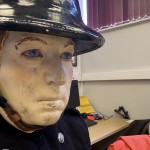 Living Mannequin Wearing 1950s Firefighter Uniform Black Helmet Yellow Leggings Essex Fire Museum mannequin-man performming as a Museum Dummy: Mannequin man wearing 1950-1960 firefighter uniform and breathing apparatus amusing the visitors for Essex Fire Museum on 26/05/2024