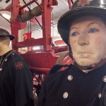 Living Mannequin Wearing 1950s Firefighter Uniform Black Helmet Yellow Leggings Essex Fire Museum mannequin-man performming as a Museum Dummy: Mannequin man wearing 1950-1960 firefighter uniform and breathing apparatus amusing the visitors for Essex Fire Museum on 26/05/2024