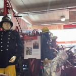 Living Mannequin Wearing 1950s Firefighter Uniform Black Helmet Yellow Leggings Essex Fire Museum mannequin-man performming as a Museum Dummy: Mannequin man wearing 1950-1960 firefighter uniform and breathing apparatus amusing the visitors for Essex Fire Museum on 26/05/2024